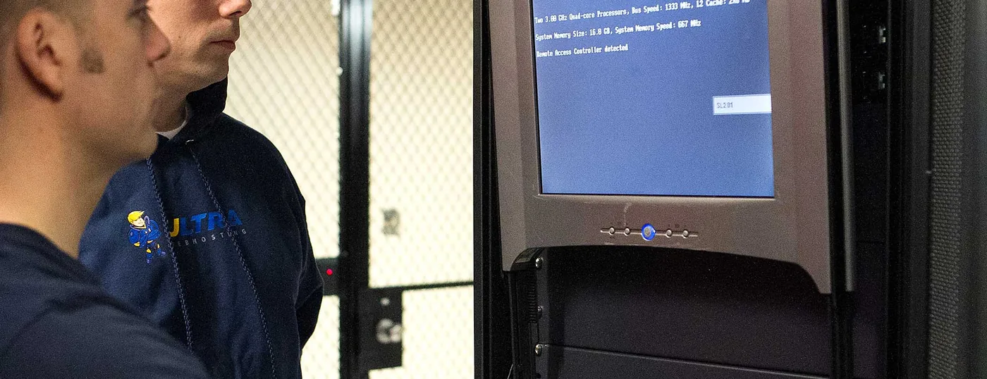 Ultra Web Hosting engineer at a wide console monitoring servers in the datacenter